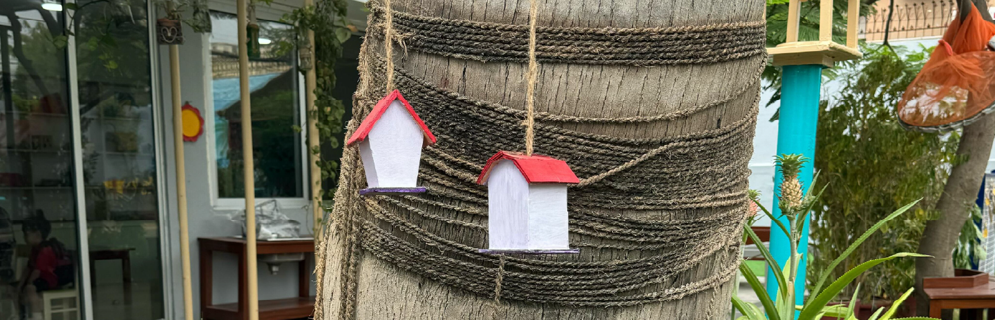 Children exploring paint materials at Kiva School