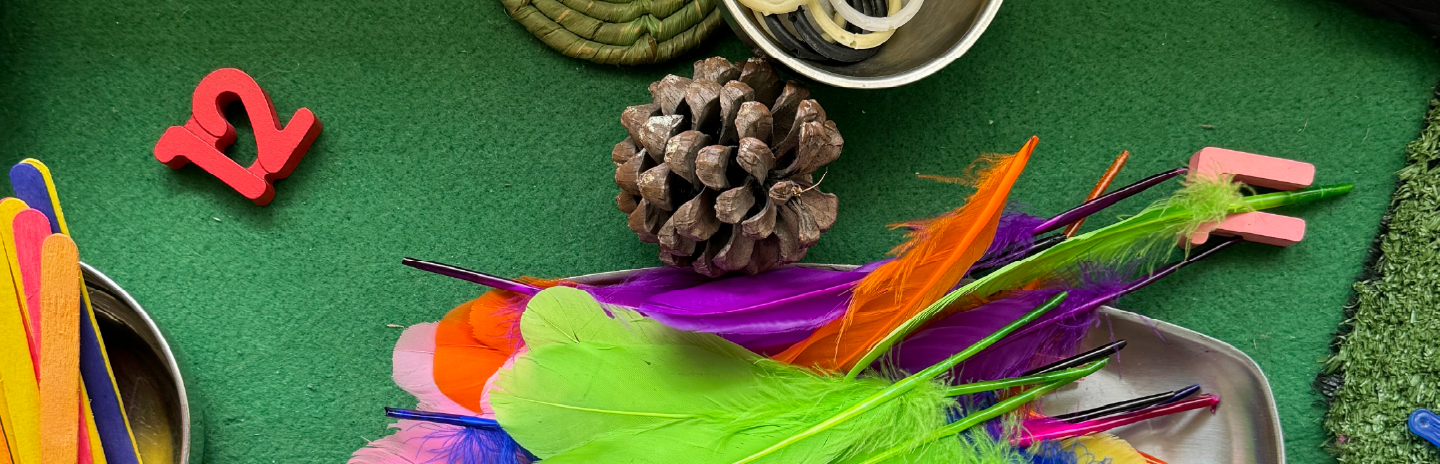 Children exploring paint materials at Kiva School