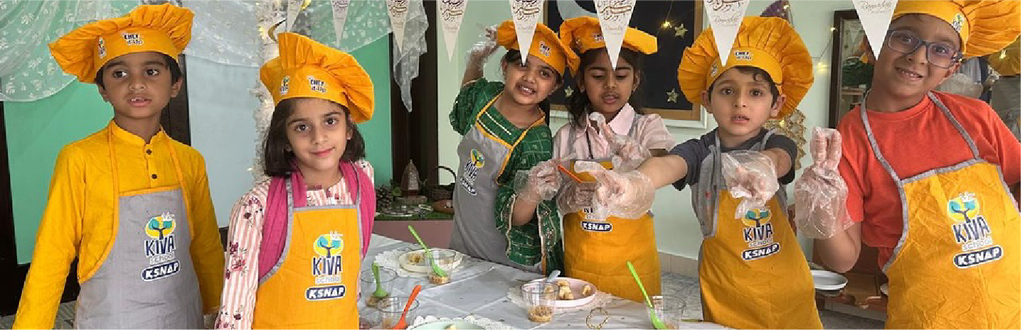 Children exploring paint materials at Kiva School