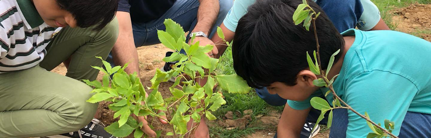 Children exploring paint materials at Kiva School