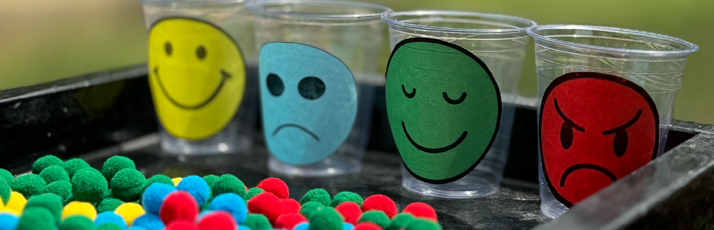 Children exploring paint materials at Kiva School